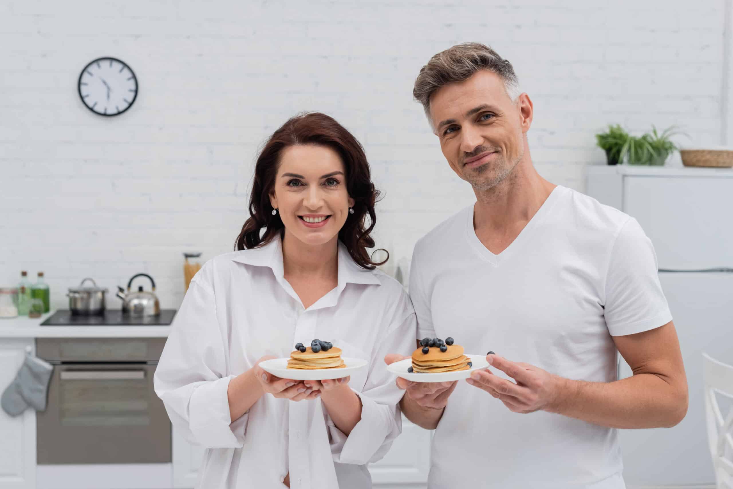 About Me 2 smiling couple holding pancakes with blueberries a 2024 11 11 22 40 33 utc 1 scaled
