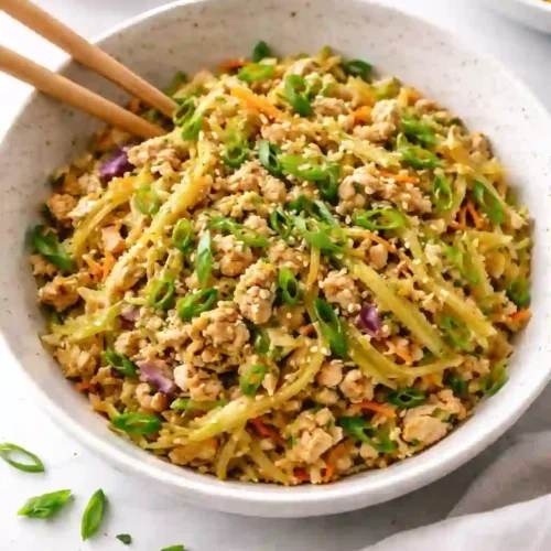 Healthy Chicken Egg Roll Bowls Made in One Skillet 1 Chicken egg roll bowls made with ground chicken, cabbage, and vegetables, served in a ceramic bowl.