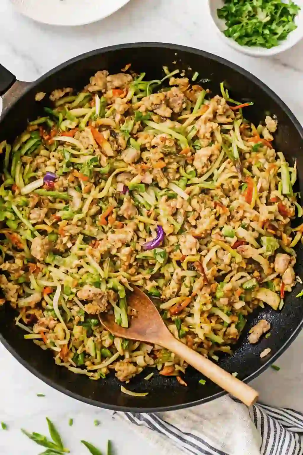 chicken-egg-roll-bowls-hero (1)_compressed Chicken egg roll bowls cooked in a skillet with ground chicken, cabbage, and vegetables.