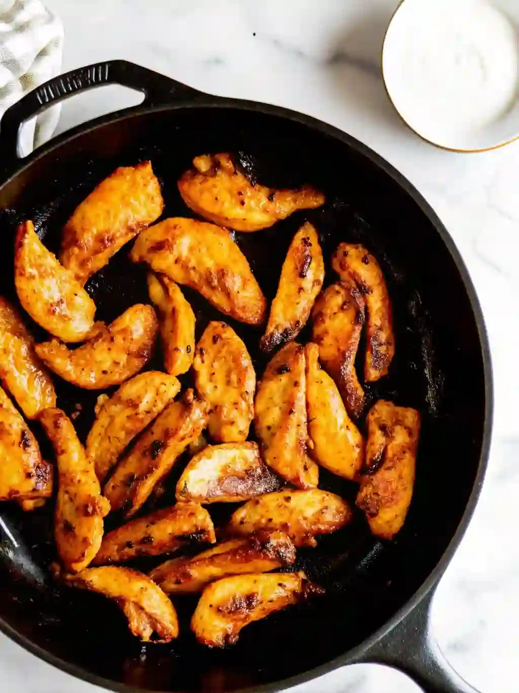 easy-chicken-fajitas-step-3-sear-chicken._compressed Seared chicken breast strips cooking in a cast-iron skillet on a stovetop