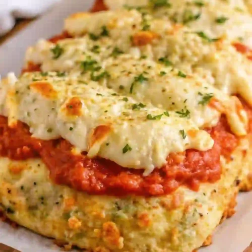 Slice of parmesan chicken meatloaf topped with marinara and melted mozzarella