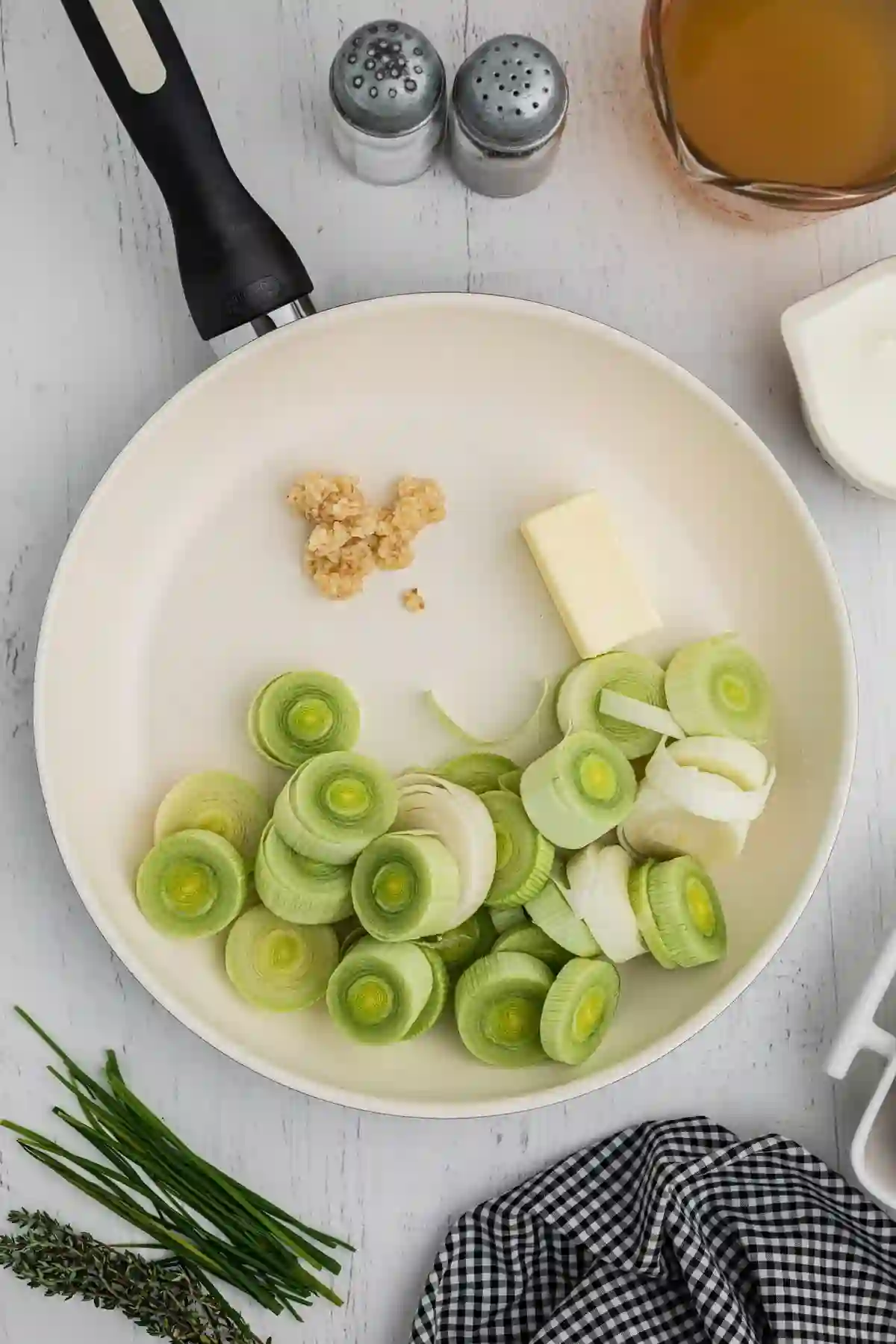 slow-cooker-potato-leek-soup-step-1._compressed Sliced leeks and minced garlic cooking with butter in a skillet