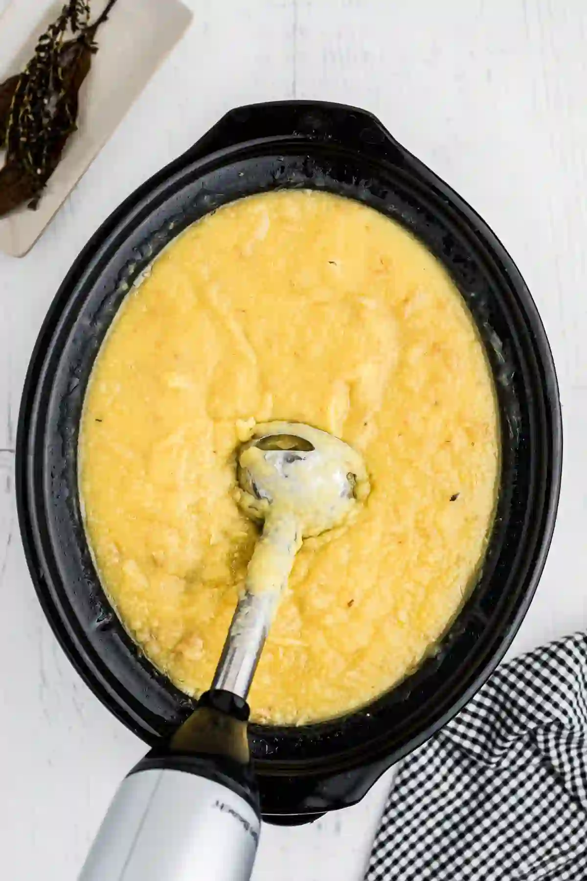 slow-cooker-potato-leek-soup-step-3._compressed Blending potato leek soup with an immersion blender in a slow cooker