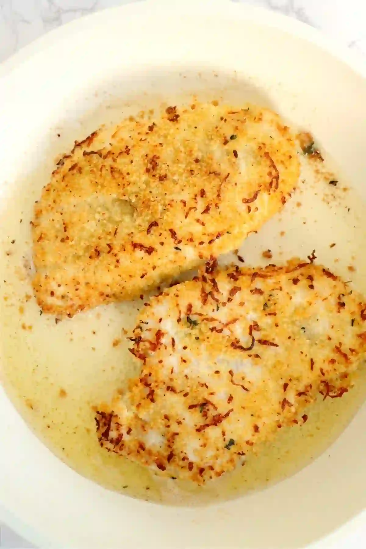 step-3-pan-fry-chicken_compressed Breaded chicken cooking in a skillet