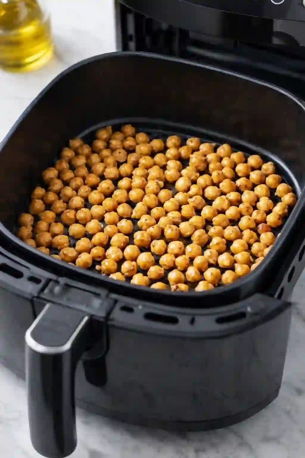 air-fryer-chickpeas-cooking._compressed Chickpeas cooking in a single layer in an air fryer basket