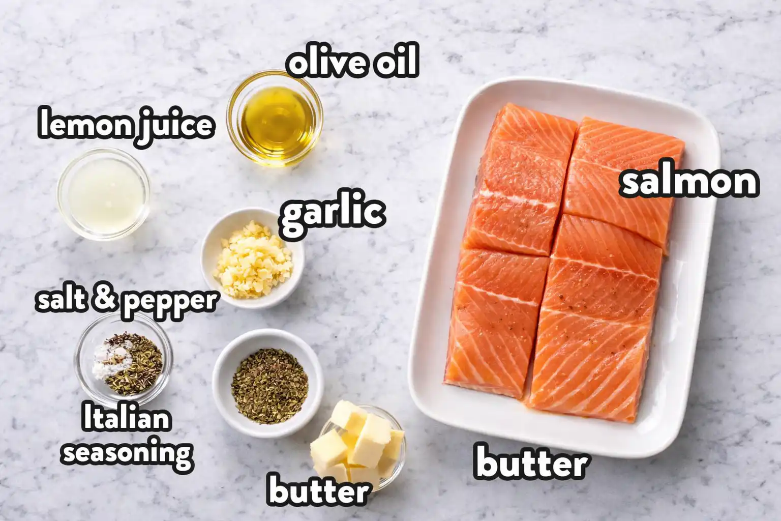 Ingredients for baked salmon with lemon butter cream sauce arranged on marble background