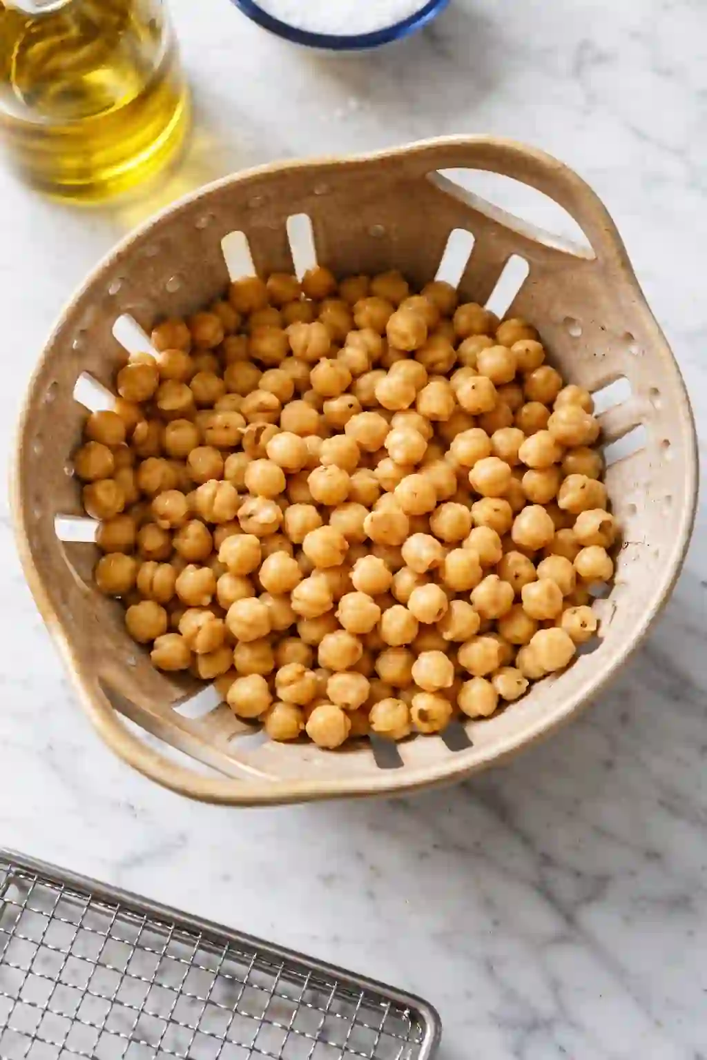 drying-chickpeas-before-air-frying._compressed Cooked chickpeas draining and drying in a colander before air frying