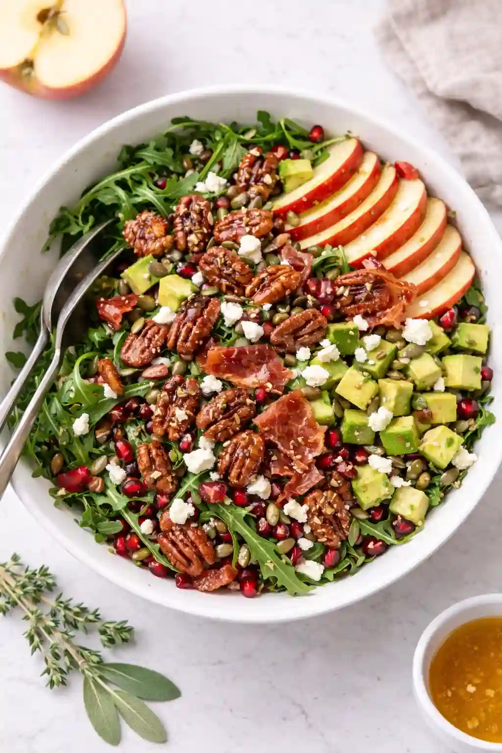 Honeycrisp apple and feta salad topped with candied pecans and crispy prosciutto
