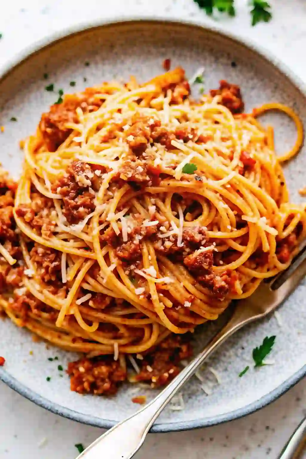 Slow-simmered spaghetti bolognese with rich meat sauce and grated Parmesan cheese.
