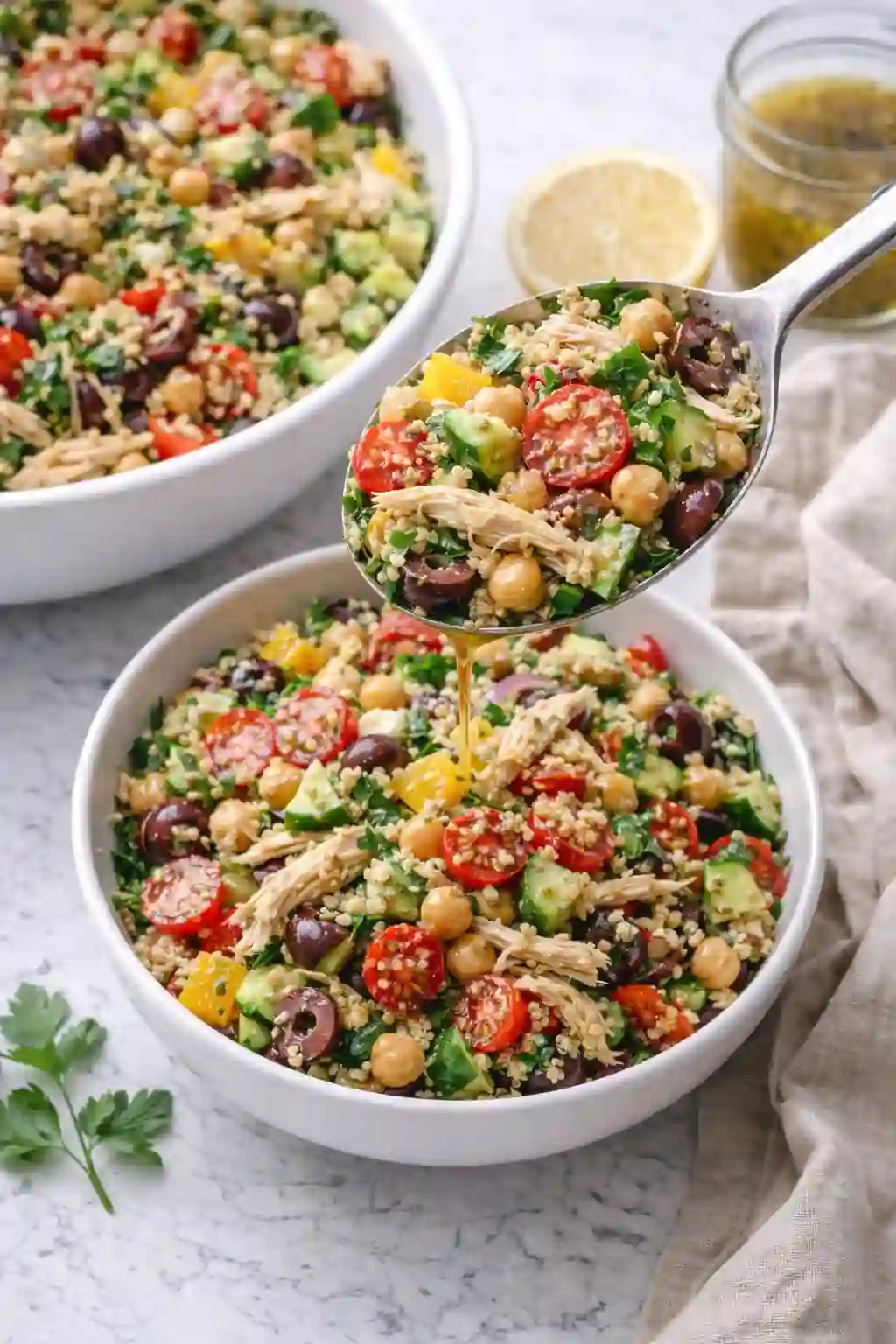 Serving Mediterranean chicken salad into a bowl