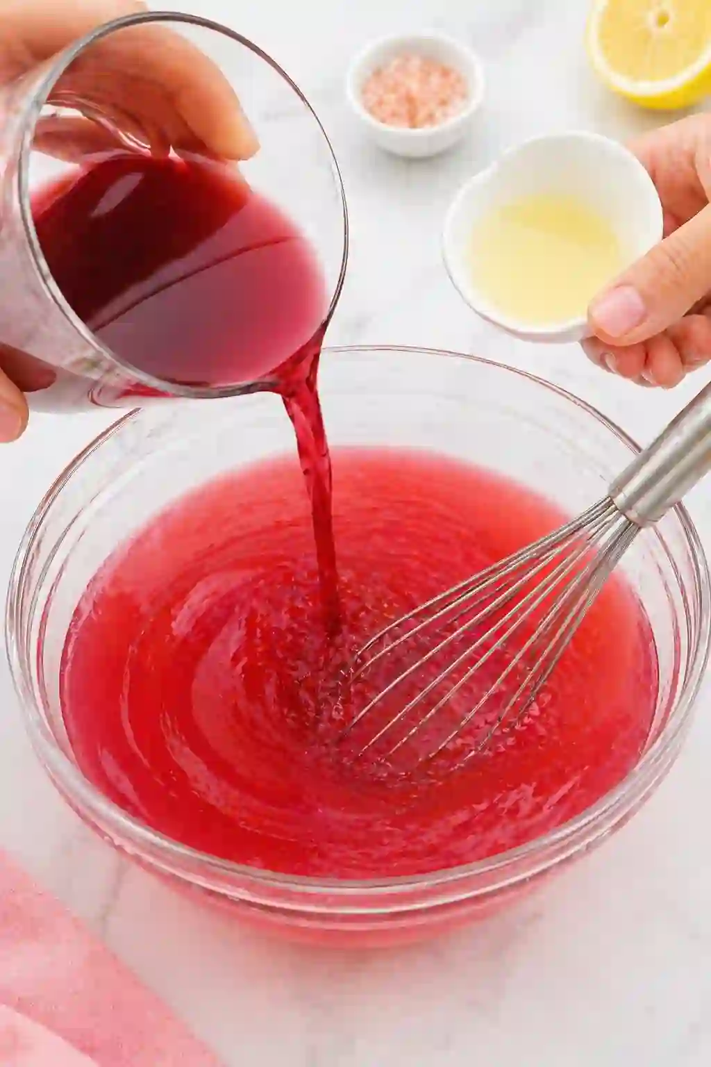 Adding cranberry juice and lemon juice to gelatin mixture for Dr Oz pink gelatin recipe for weight loss