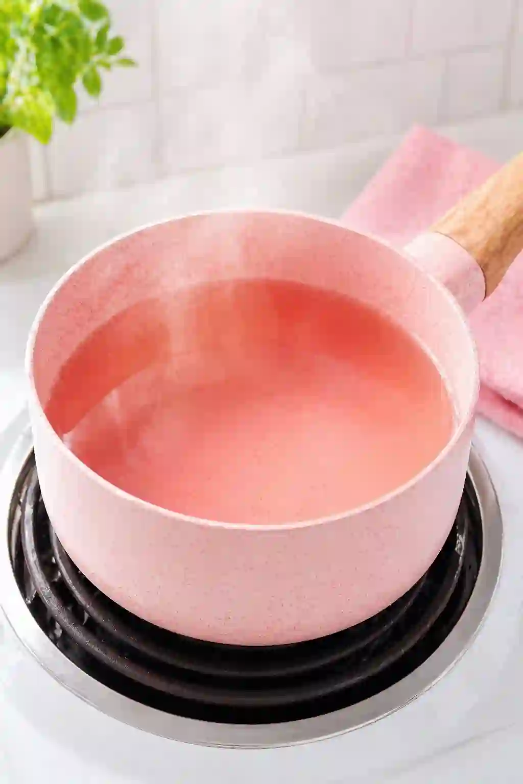Heating liquid in a saucepan for Dr Oz pink gelatin recipe for weight loss until hot but not boiling
