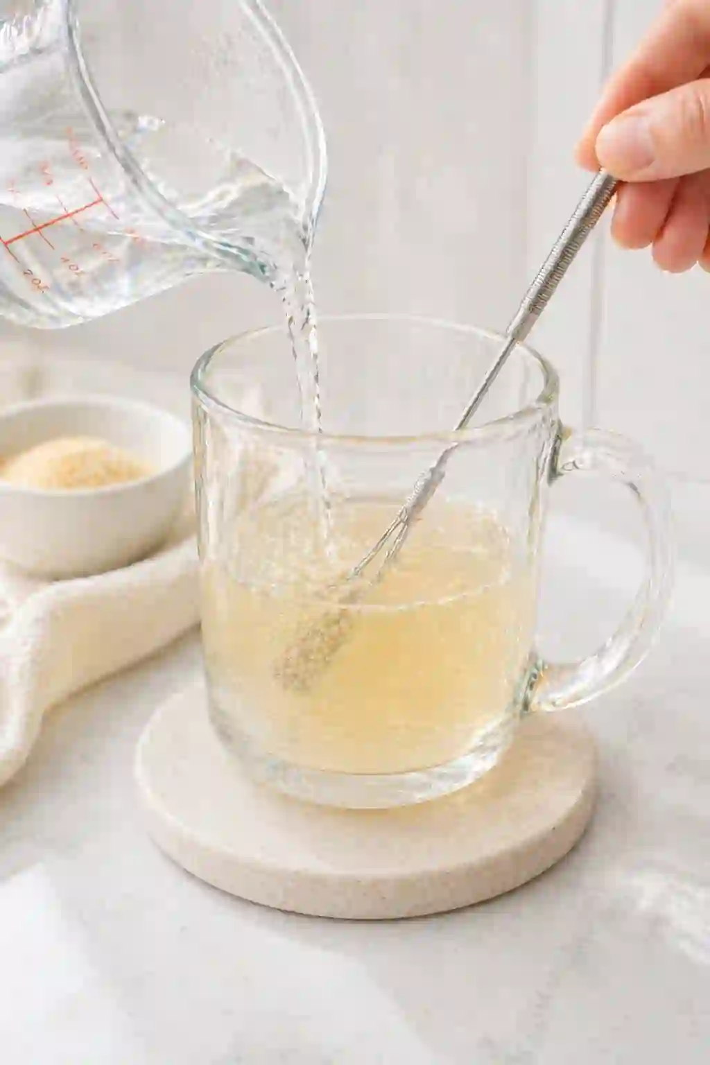 Mixing bloomed gelatin with warm water until fully dissolved for Dr William Li gelatin recipe for weight loss