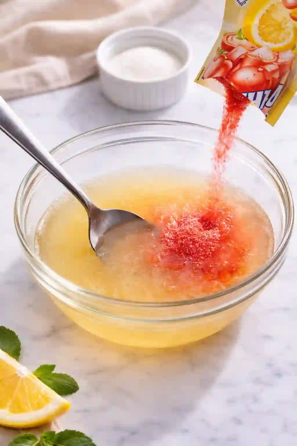 adding flavor powder to dissolved gelatin mixture in bowl