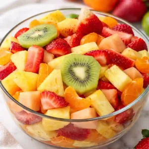 Tropical Fruit Salad Recipe: Ultimate 15 Minute Treat 1 Tropical fruit salad recipe in a glass bowl with pineapple, kiwi, strawberries, and mandarin oranges