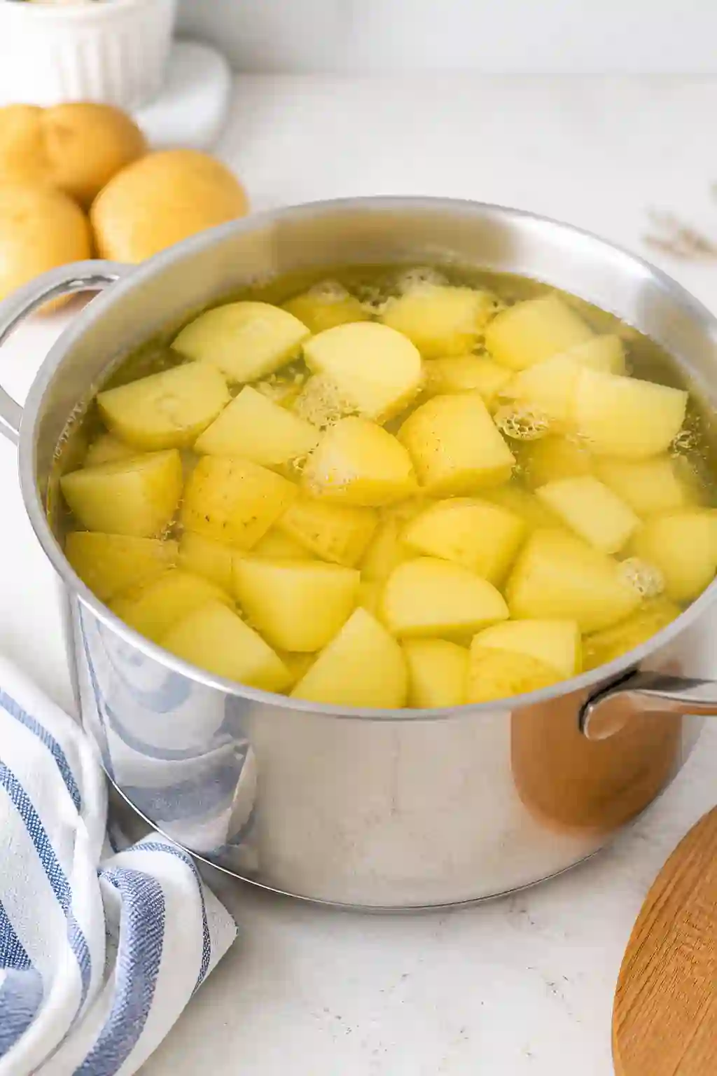 Potatoes boiling in a pot with clear water for BBQ side dishes recipes potato salad